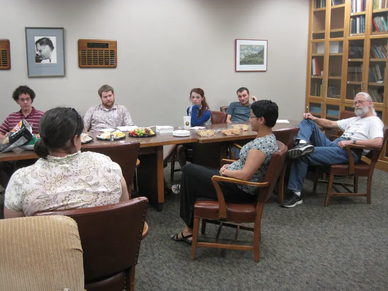 A shot of the end of the table, with participants talking amongst themselves.